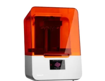 3D printer with an orange cover and white base, used for creating customized orthodontic appliances, highlighting advanced technology in orthodontics.